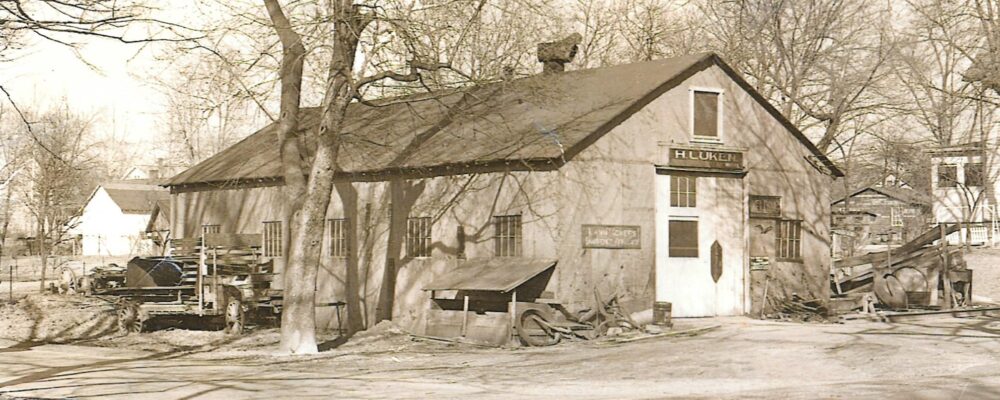 (in black and white) blacksmith, welding, and repair shop