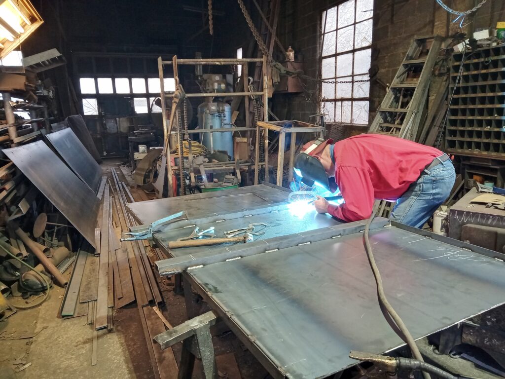 man welding carbon steel using MIG process