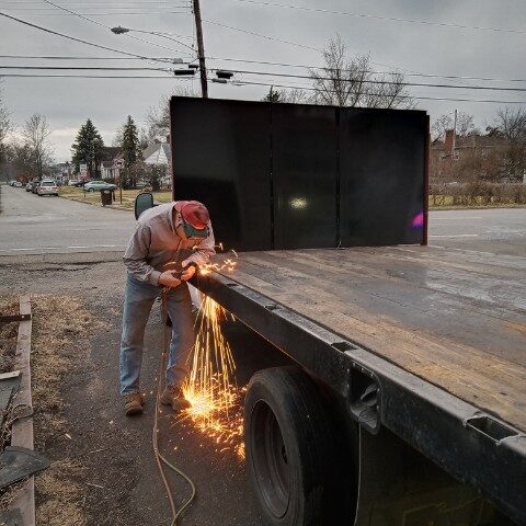 man using oxyacetylene torch to cut metal